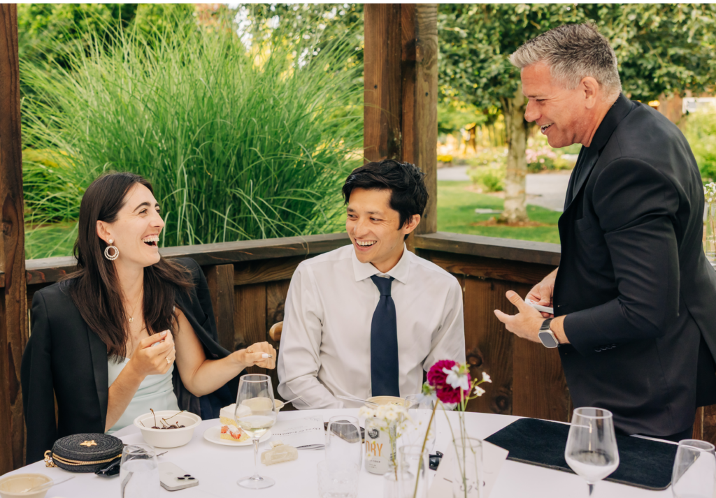 Magician performing intimate private event entertainment for guests at an elegant wedding reception table