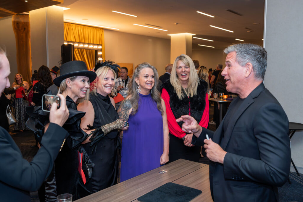 Corporate cocktail hour entertainment with a close-up magician engaging guests at a corporate event