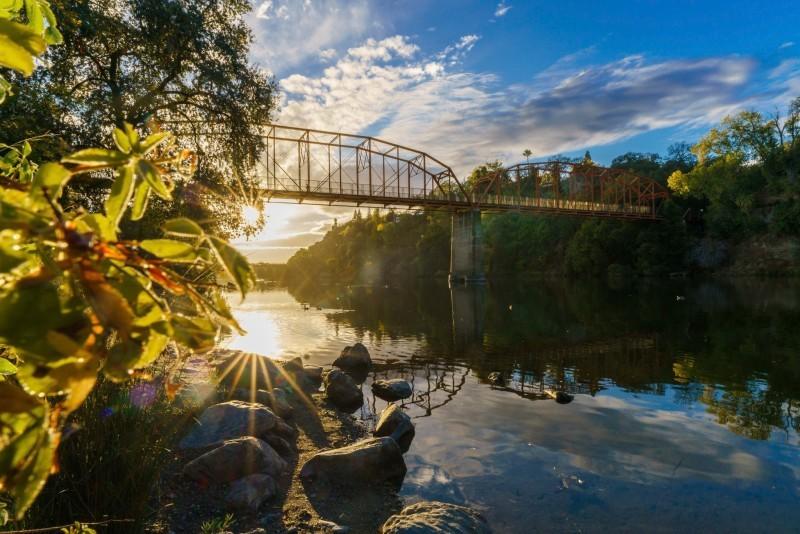 American River Parkway trail with river and trees in Sacramento