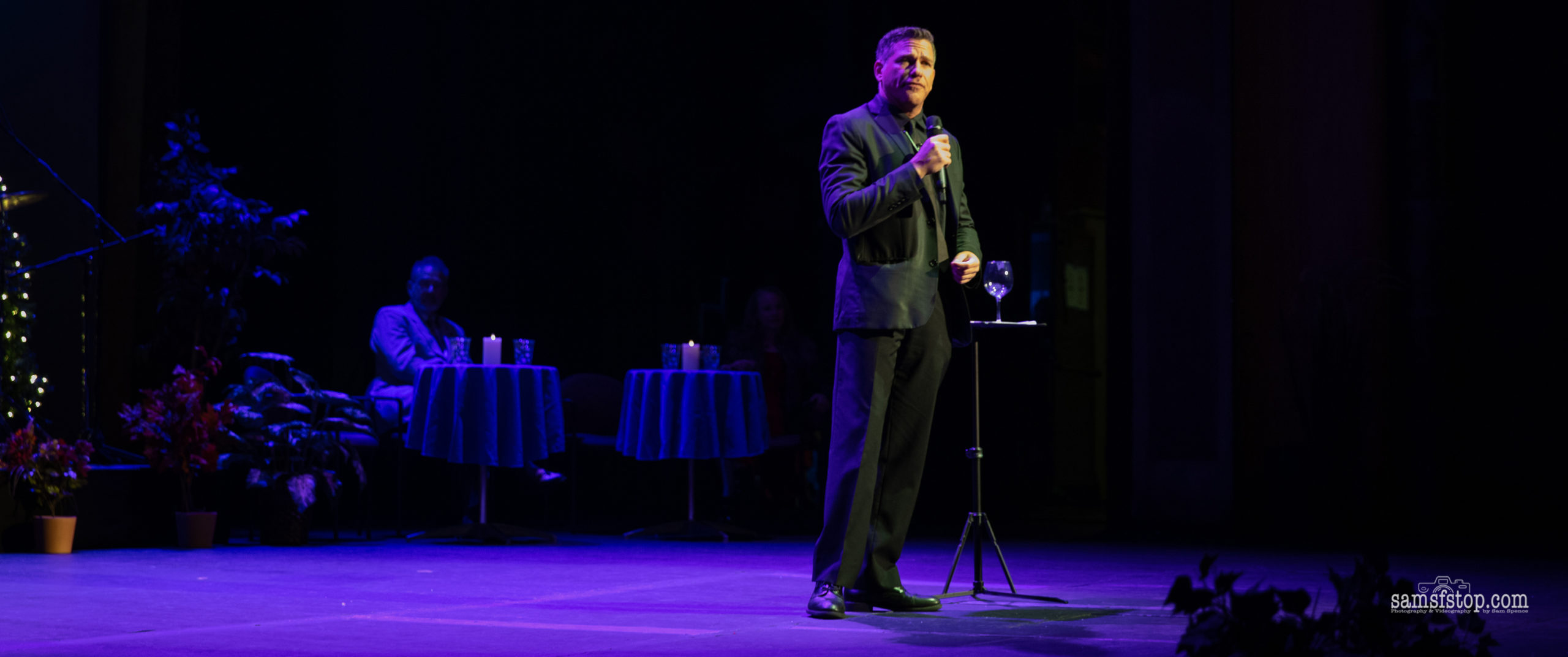 Corporate magician Zach Waldman performing on stage Corporate magician Zach Waldman performing on stage
