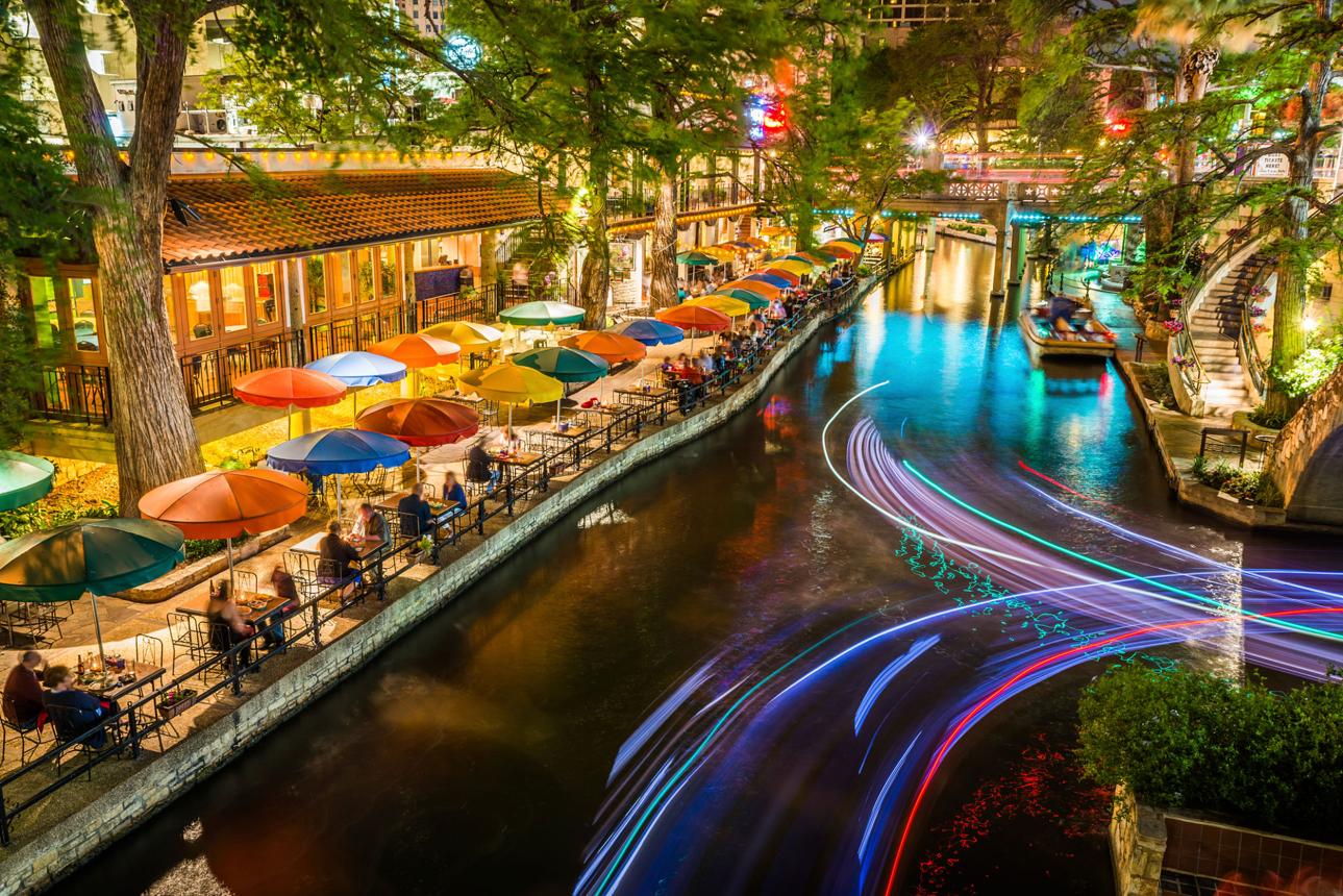 San Antonio River Walk with boats, restaurants, and riverside walkway